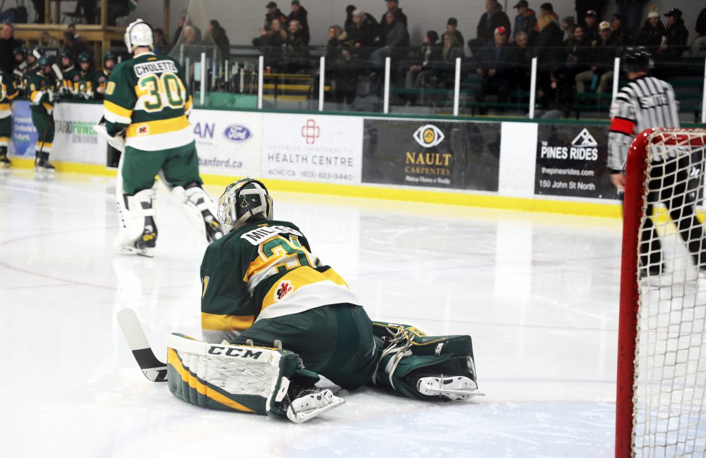A photo of a goalie stretching.