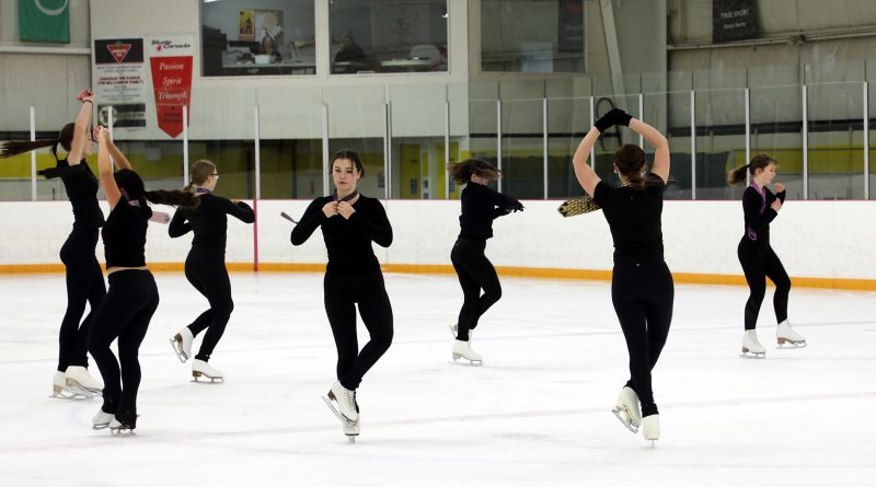 A group of skaters perform a routine.