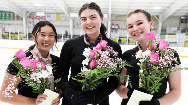 Three figure skaters holding bouqets.