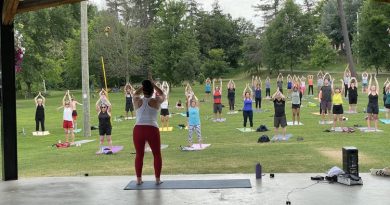 A photo of a yoga class in a park.