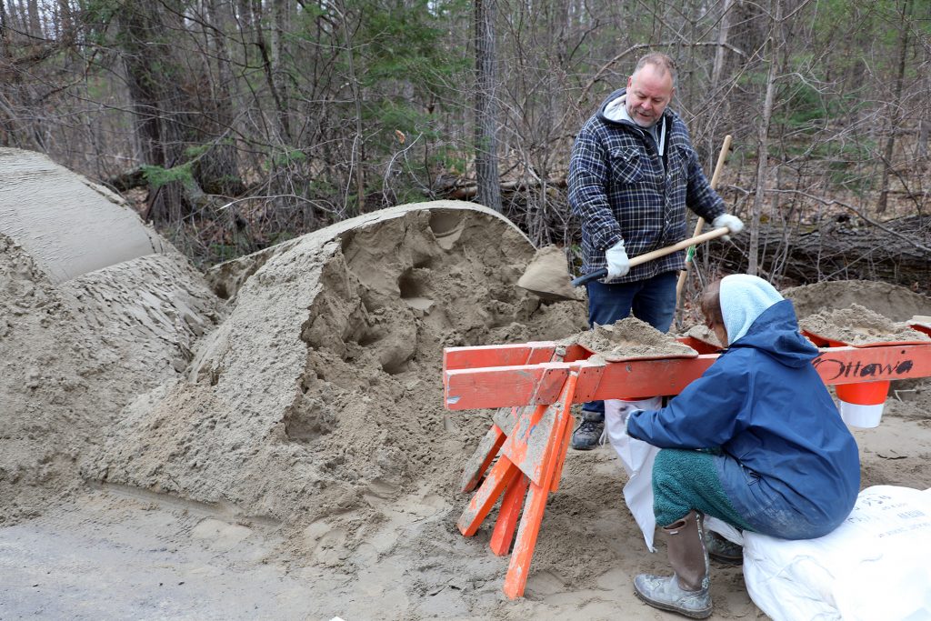 A photo of people filling sandbags.