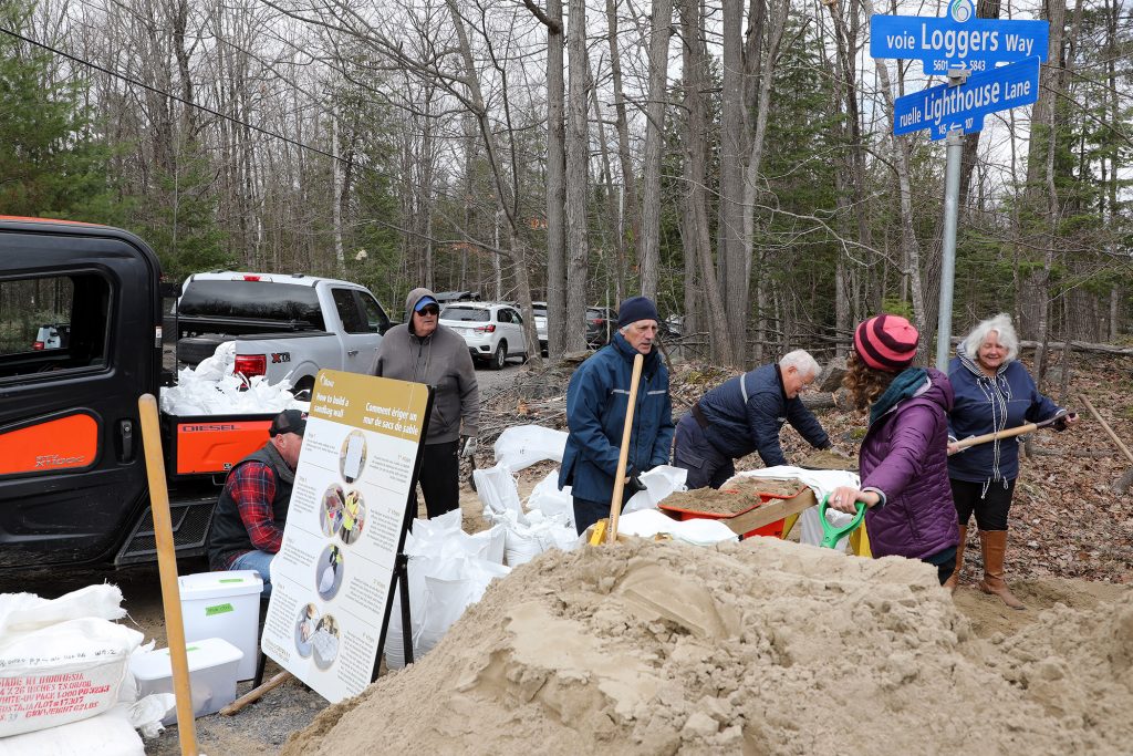 A photo of people shovelling sand.