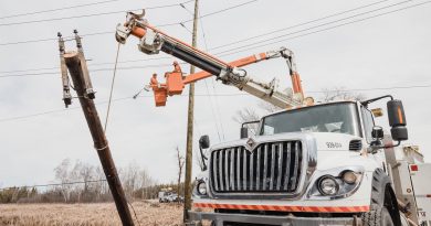 A photo of a hydro pole being repaired.