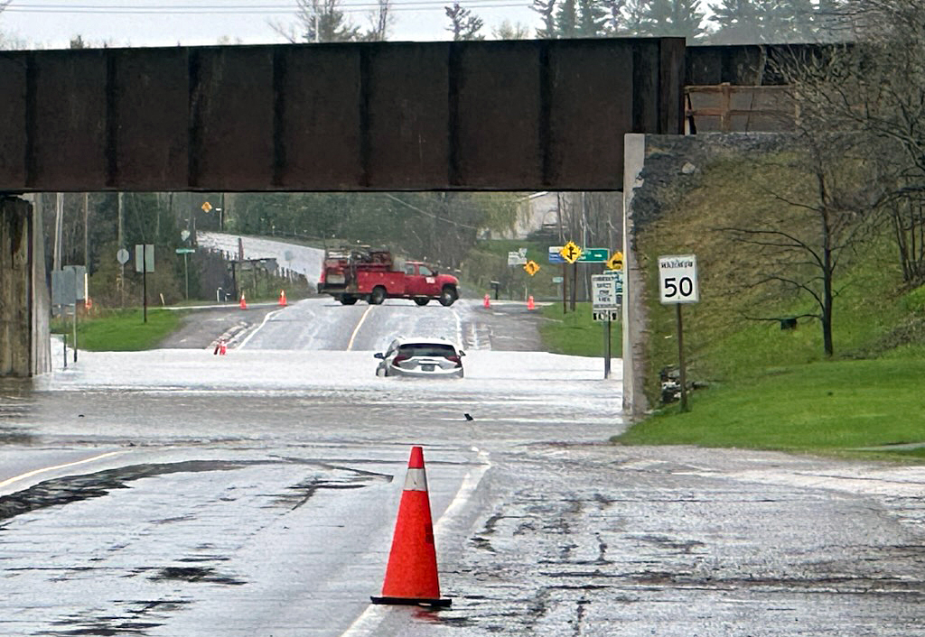 A photo of a car submerged in water along Hwy. 29.