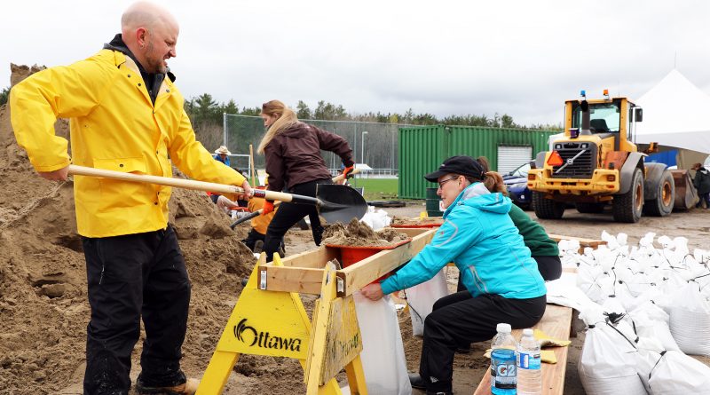 A photo of people filling sandbags.