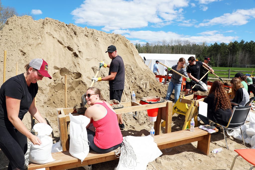 A photo of people filling sandbags.