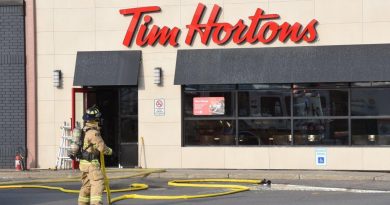A firefighter approaches a Tim Hortons restaurant.