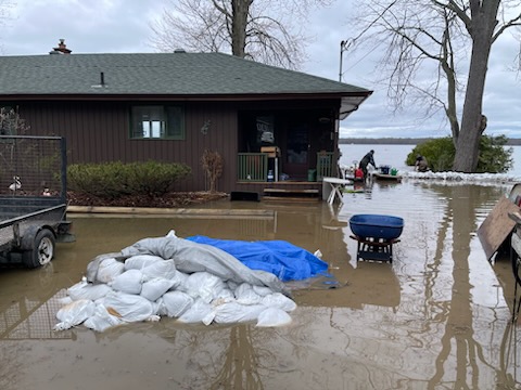 A photo of a home surrounded by high water.