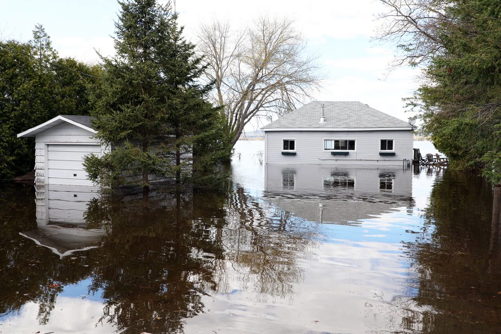 A photo of a home surrounded by water.