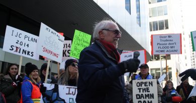 A photo of a man speaking at a protest.