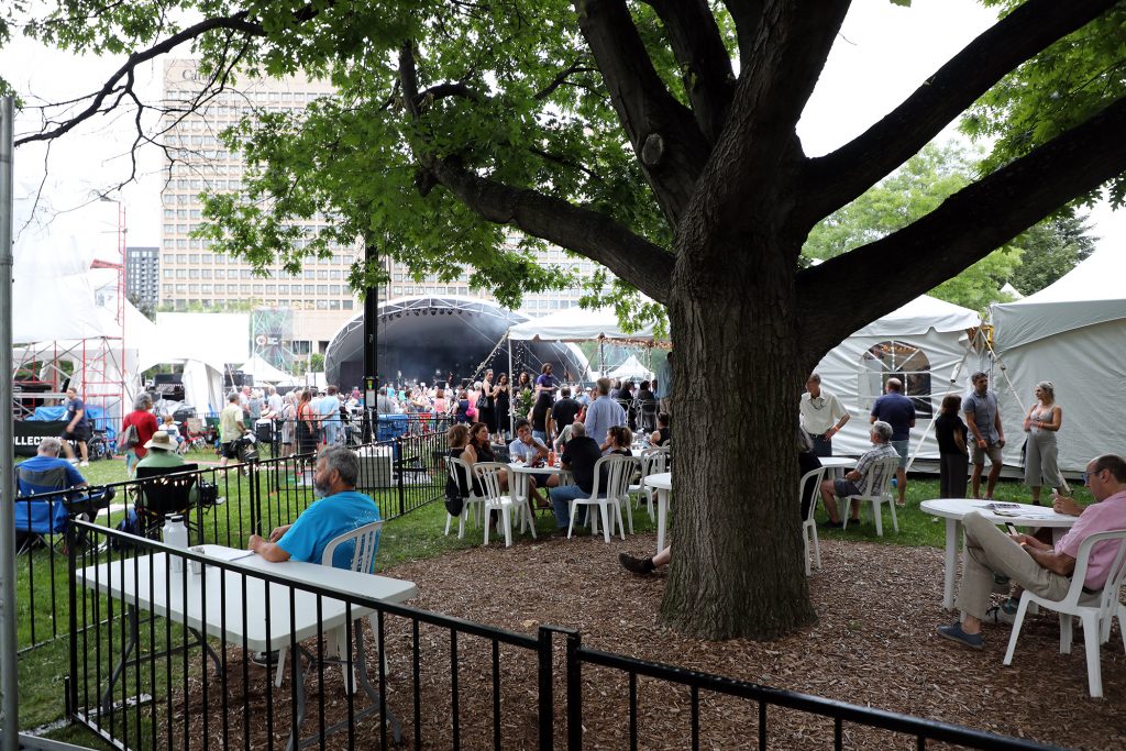 A photo of a tent and people enjoying the festival.