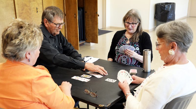 A photo of people playing cards.