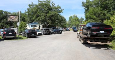 A photo of a car on a tow truck.