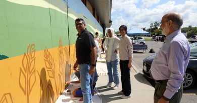 A group of people work on a mural in Dunrobin.