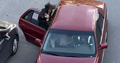 A photo of a woman being dragged by a car.