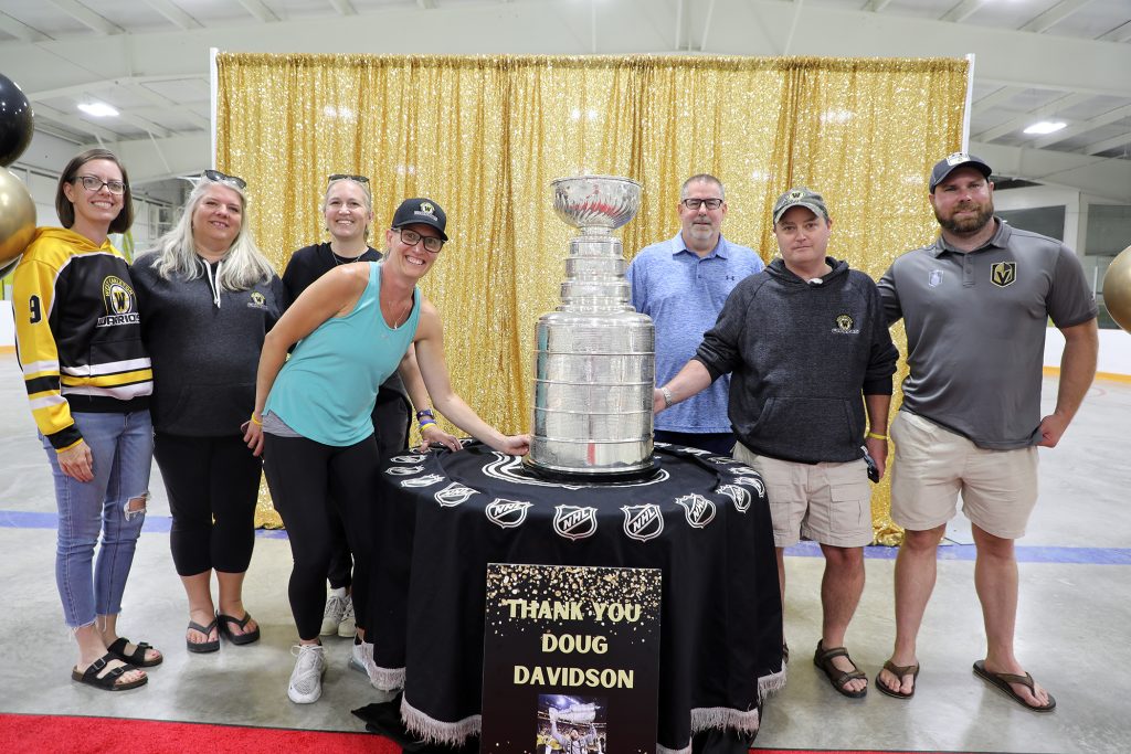 A group poses with the Cup.