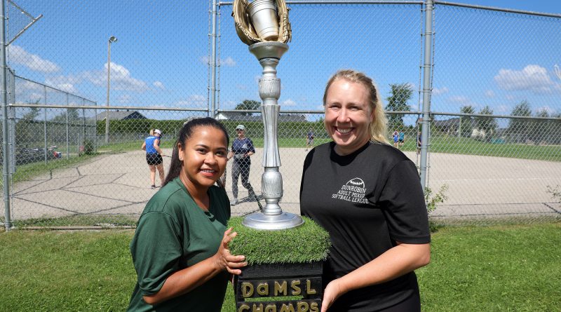 From left, 2023 team organizers Rosey Matternich and Lauren DeRoche pose with the DASL championship trophy mad by the third organizer Laurie Darras, who was absent at the time of the photo. Photo by Jake Davies