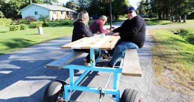 A photo of a picnic table with wheels.