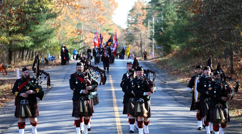 A photo of a pipe band leading a parade.
