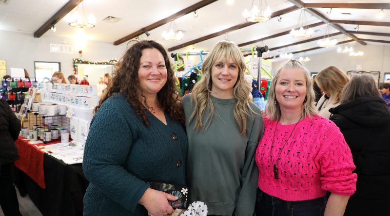 Three people pose for a photo.