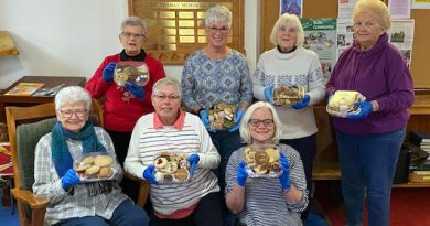 A group of ladies pose with their cookies.