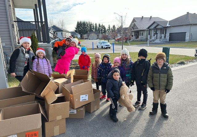 A photo of kids with boxes.