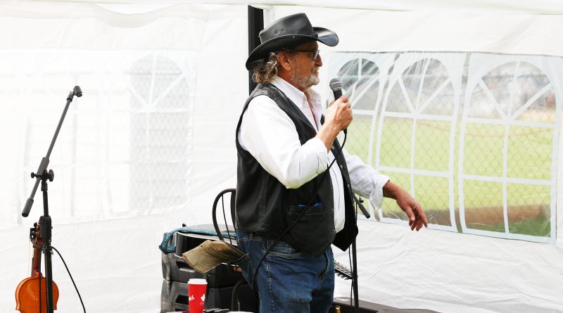A photo of a man speaking at a podium.