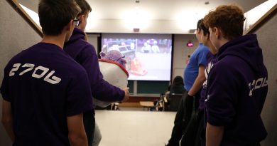 A photo of people watching a video.