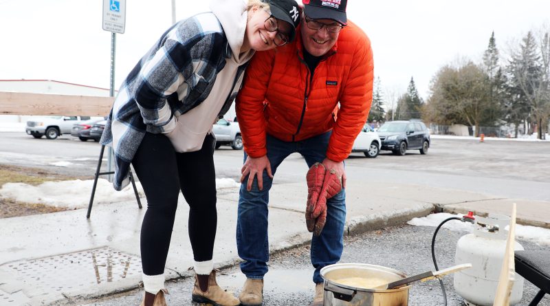 two people boil taffy.