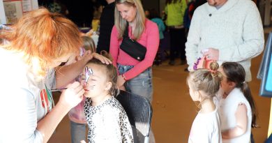 A photo of a child getting their face painted.