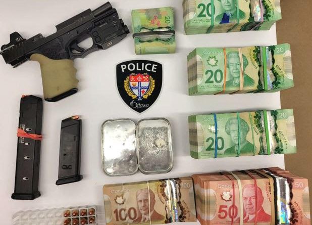 A photo of drugs, money and a gun.