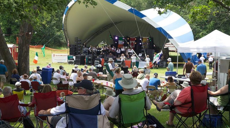 People listen to music at a gazebo.