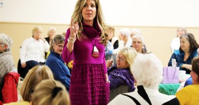 A woman wears a purple dress.