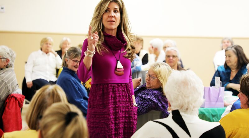 A woman wears a purple dress.
