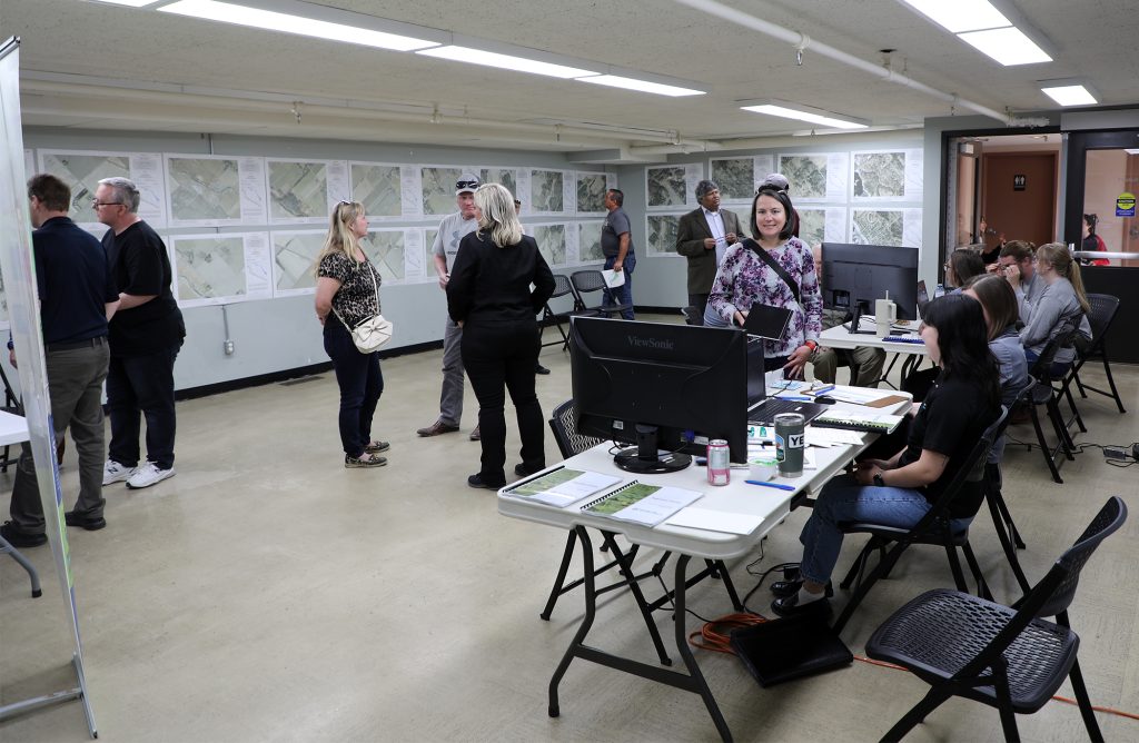 A photo of people looking at maps.