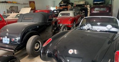 A photo of a bunch of cars in a garage.