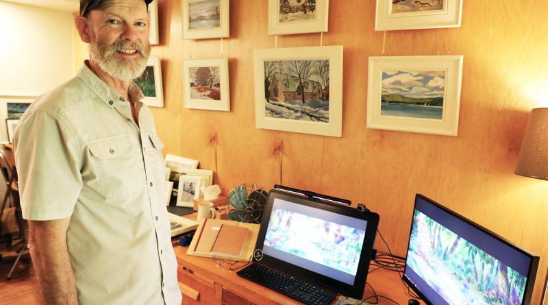 An artist poses in front of his art.