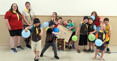 Beavers pose around a pinata.