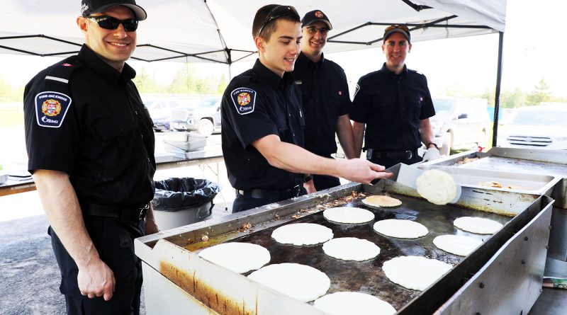 Firefighters make pancakes.