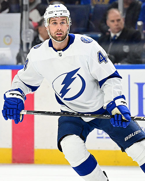 A hockey player skates down the ice.