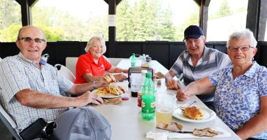 Four people eat lunch at a golf club.