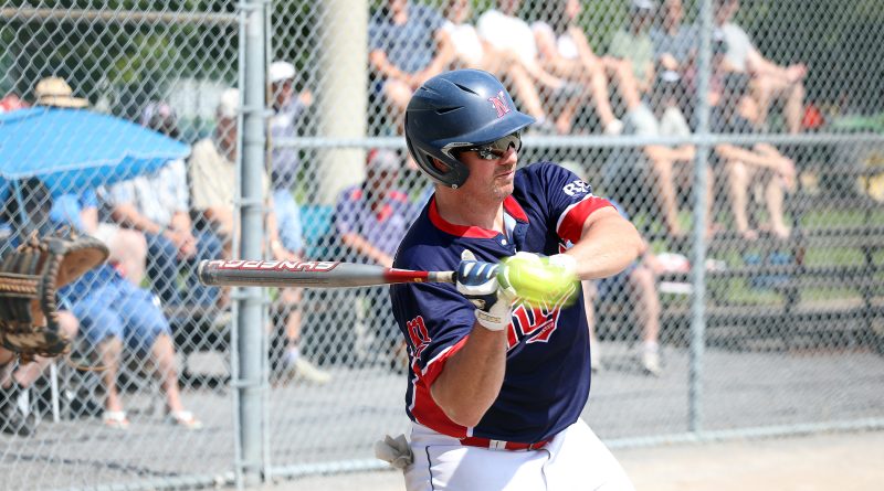 A ball player swings a bat.