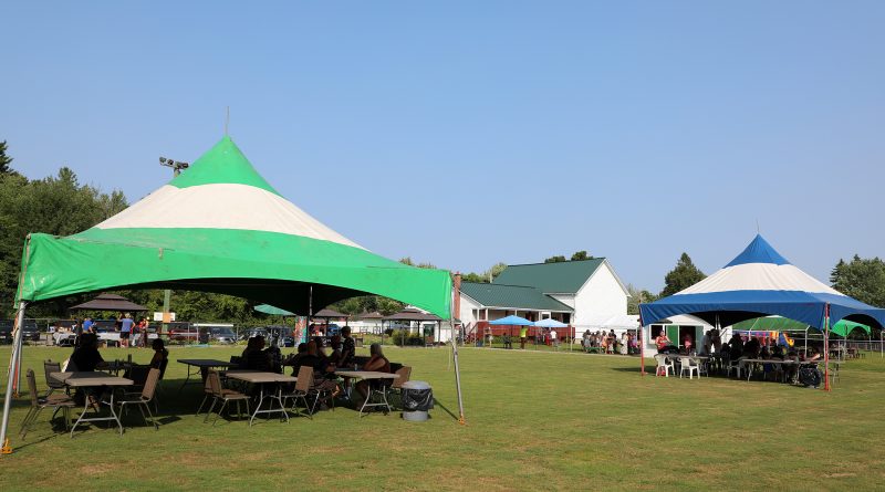 A photo of tents and the community centre.
