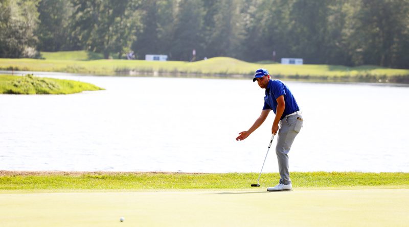 A player talks to his ball during a putt.
