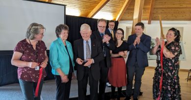 A photo of people cutting a ribbon.