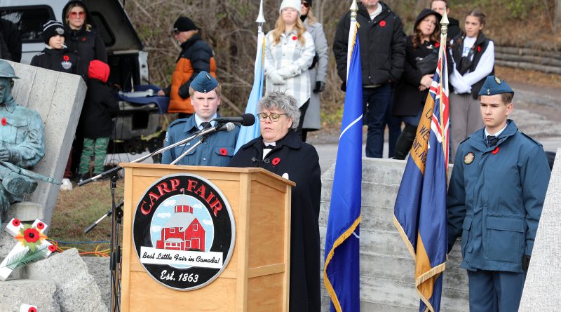 A woman speaks at a podium.