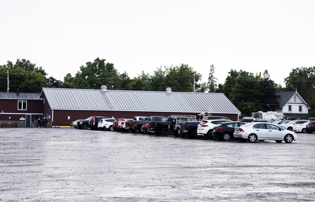 A photo of cars parked at the Carp ag hall.