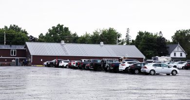 A photo of cars parked at the Carp ag hall.