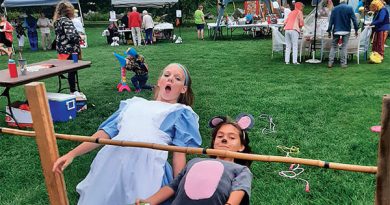 Two children do the limbo.