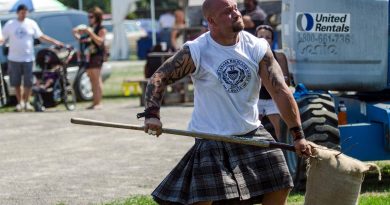 A man competes in the highland games.